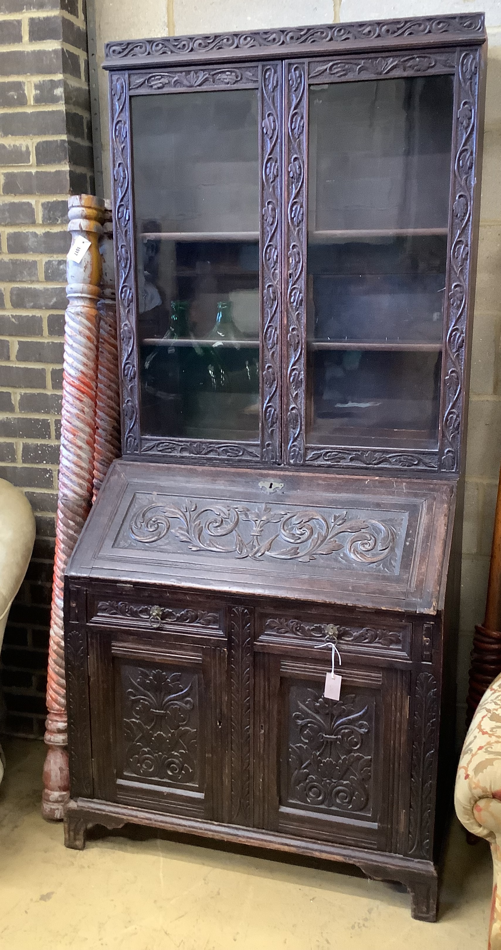 A Victorian carved oak bureau bookcase, width 94cm, depth 54cm, height 203cm